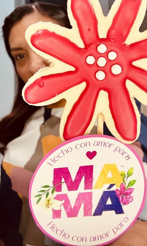 Galleta decorada de flor Margarita roja sostenida por Viry Grc